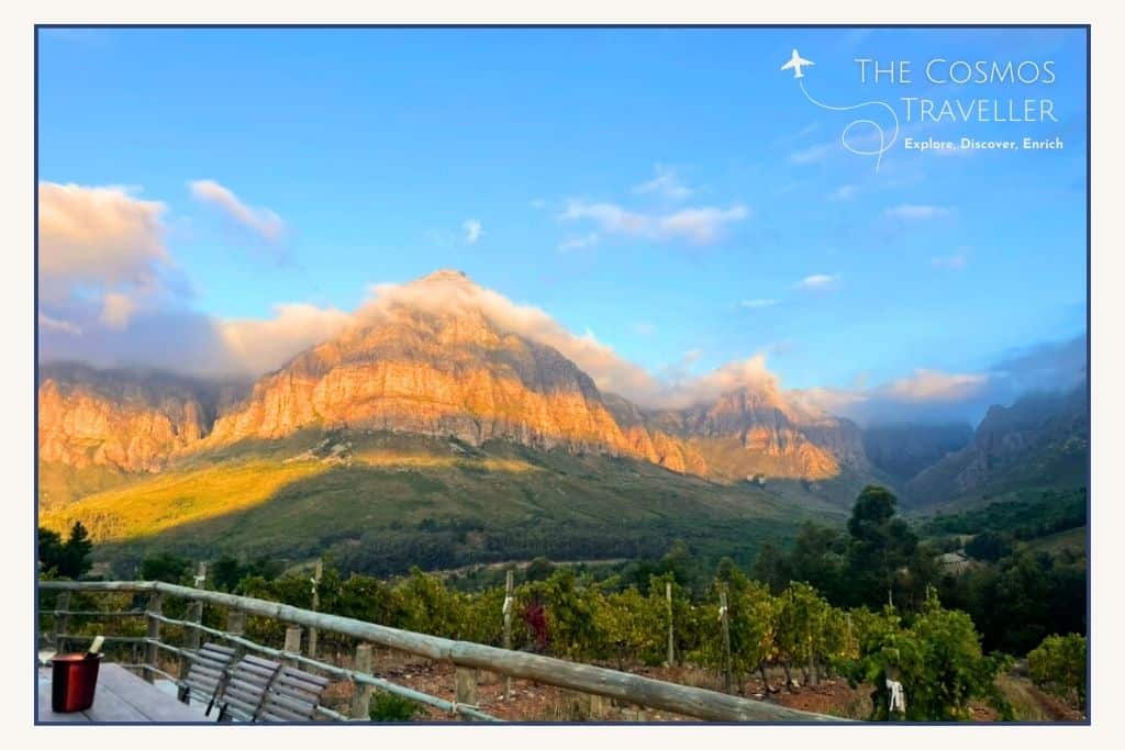 Dramatic clouds swoop over the top of these Stellenbosch mountains at sunset.