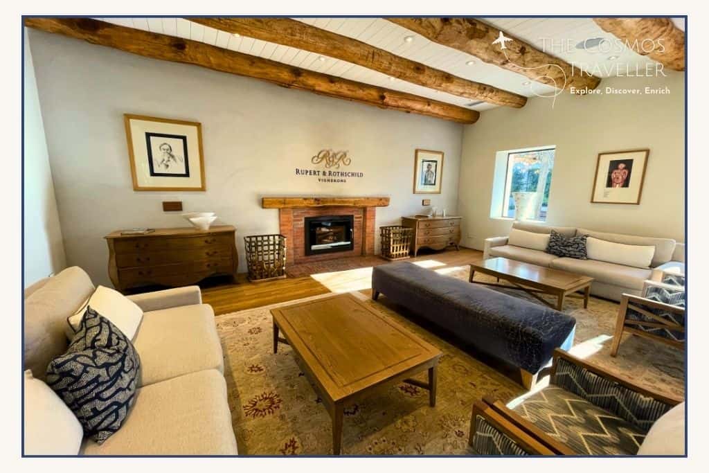 Rupert and Rothschild Wine Estate logo is mounted above the fireplace of this cosy room.