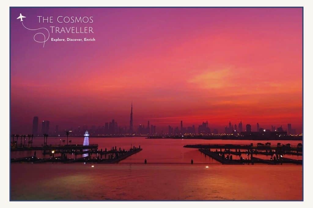 Dubai skyline at sunset - the sky is vibrant with pink colours.