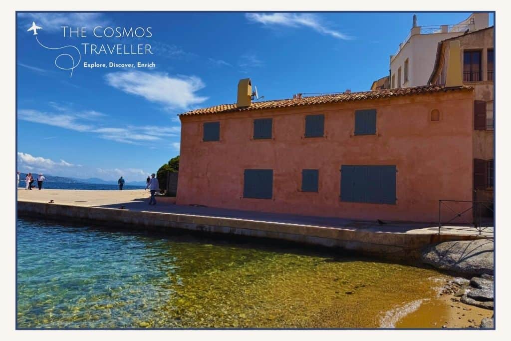 The pink house of La Ponche in Saint-Tropez sits above the gentle waters of the beach.