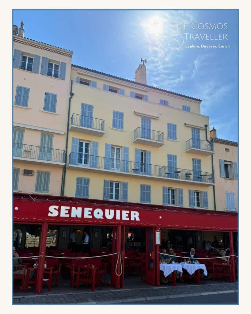 The red canopies of Sénéquier restaurant on the ground floor of fishermen’s cottages in Saint-Tropez harbour.