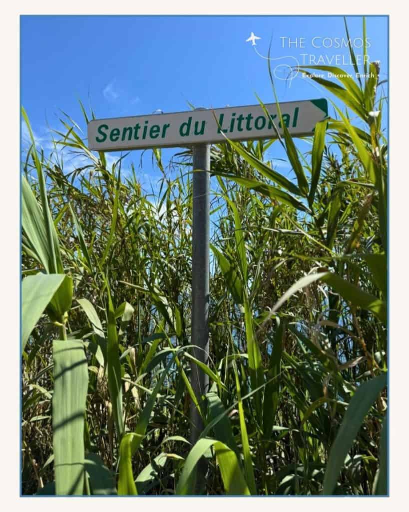 A sign marks the start of the Sentier du Littoral coastal path in Saint-Tropez.
