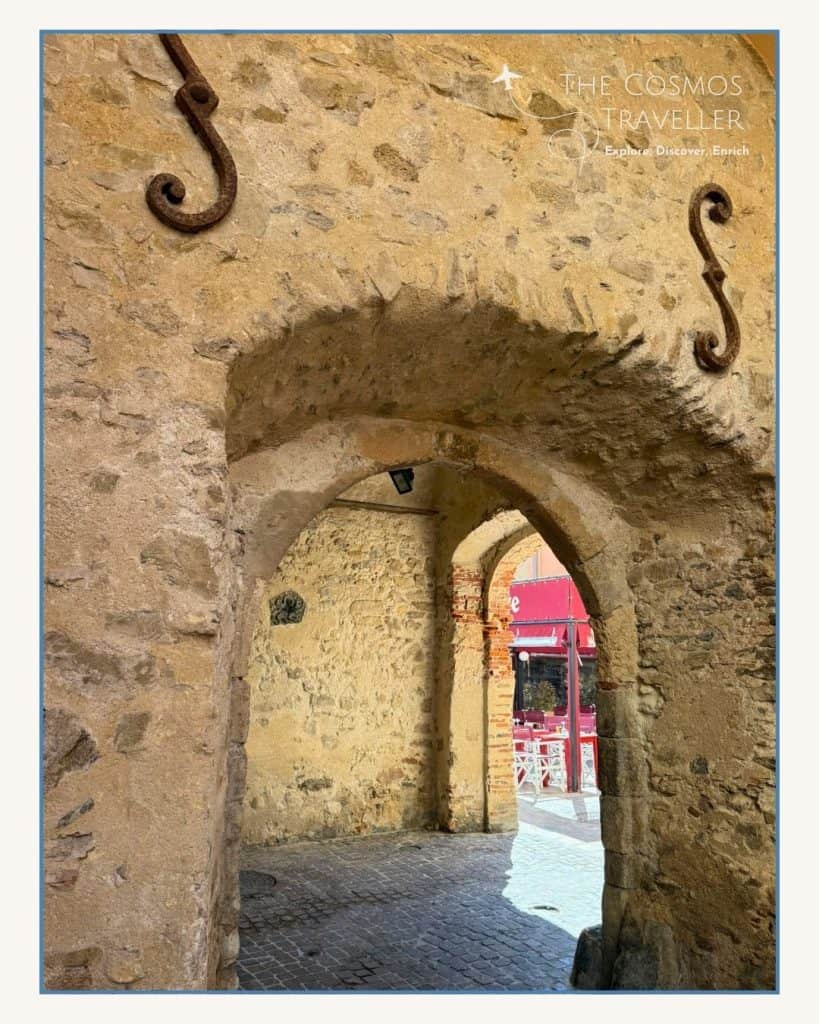 Stone archways over cobbled streets mark the route from the harbour to La Ponche in Saint-Tropez.