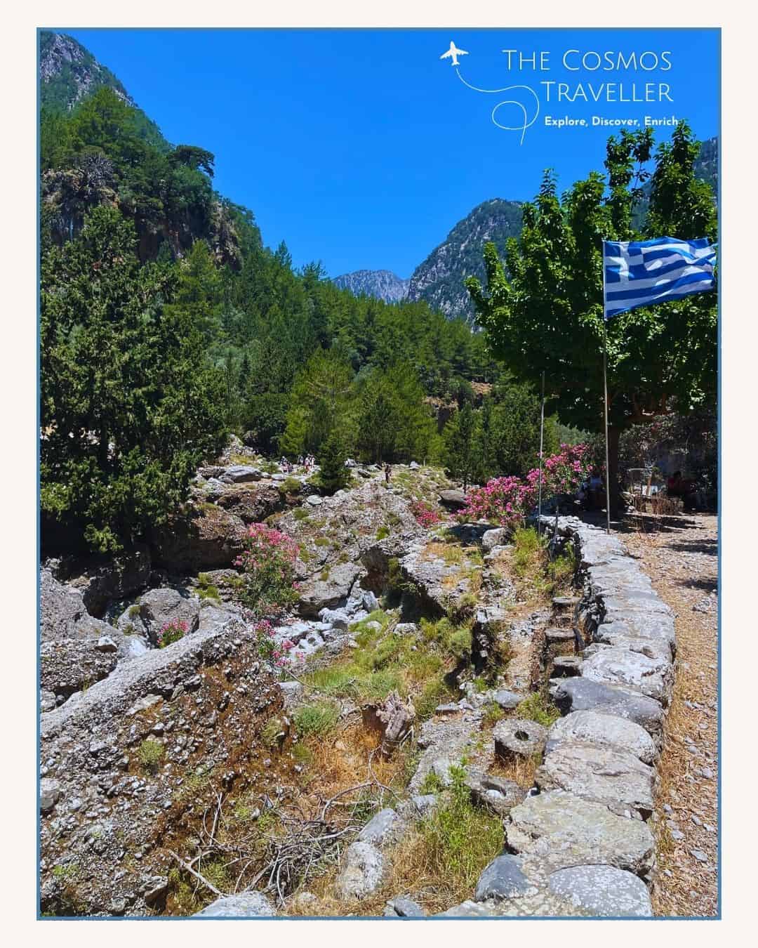 Greek flag fluttering in the wind at the abandoned village of Samaria in Crete.