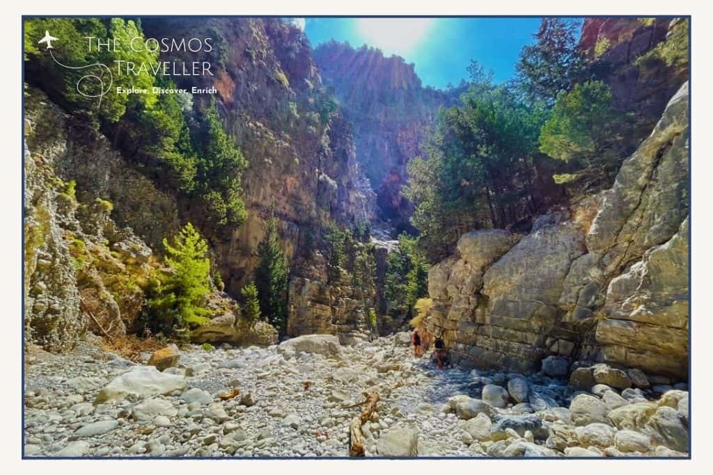 Rocky riverbed with dramatic cliffs along the Samaria Gorge hike in Crete.