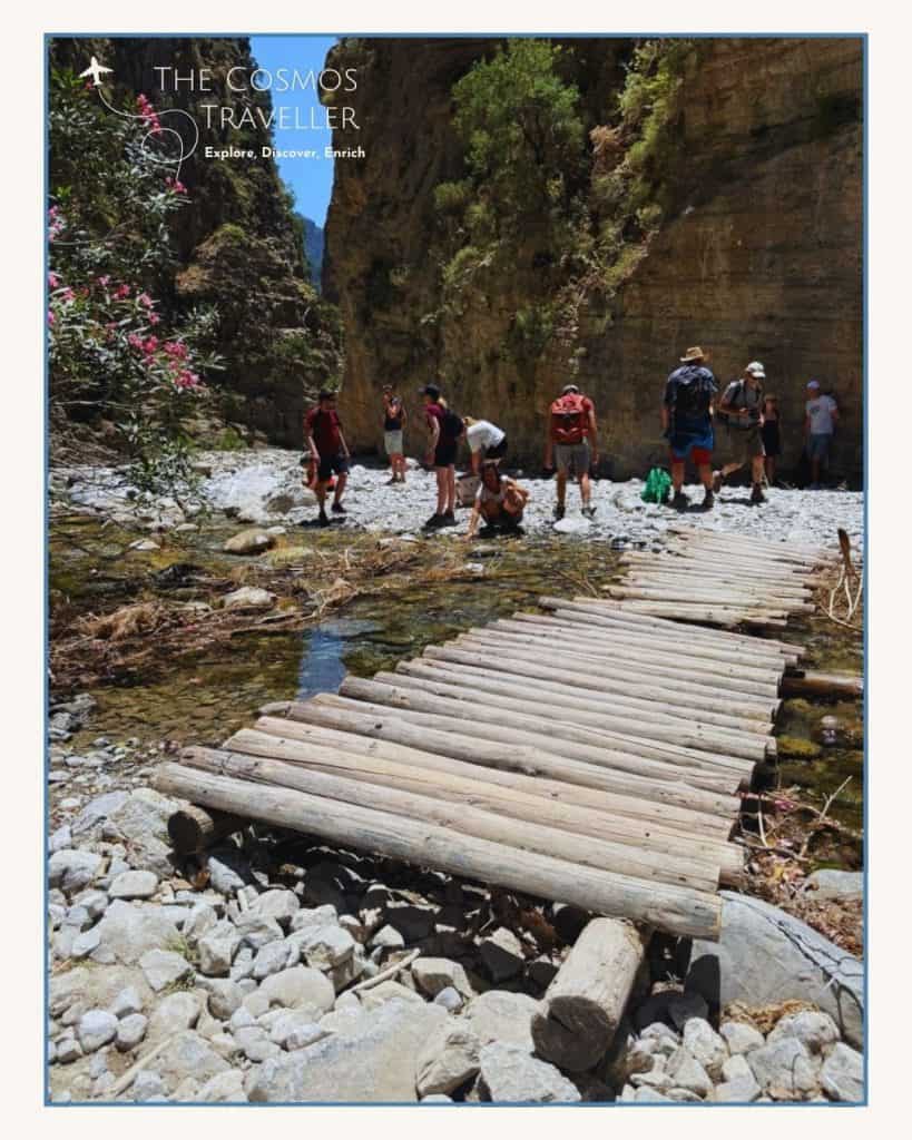 Wooden bridge crossing the rocky riverbed along the Samaria Gorge hiking trail in Crete.