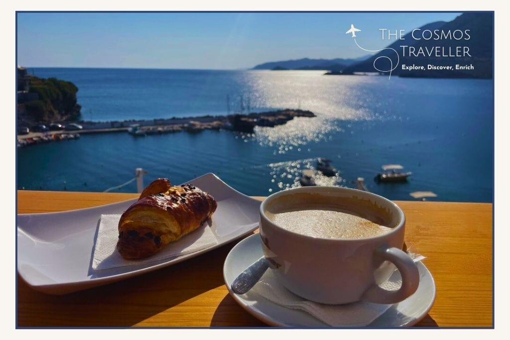 Coffee and croissant on a table overlooking the sea at sunrise from Harbour Café in Bali, Crete.