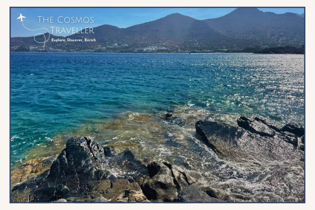 Distant view of Elounda hills and deep blue sea near Kolokytha, capturing the scenic beauty of hidden beaches in East Crete.