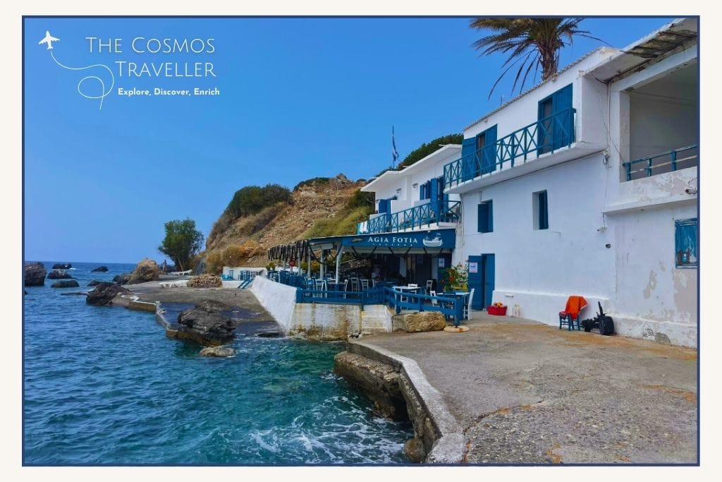 A greek seaside taverna in blue and white perched over a tiny slipway.