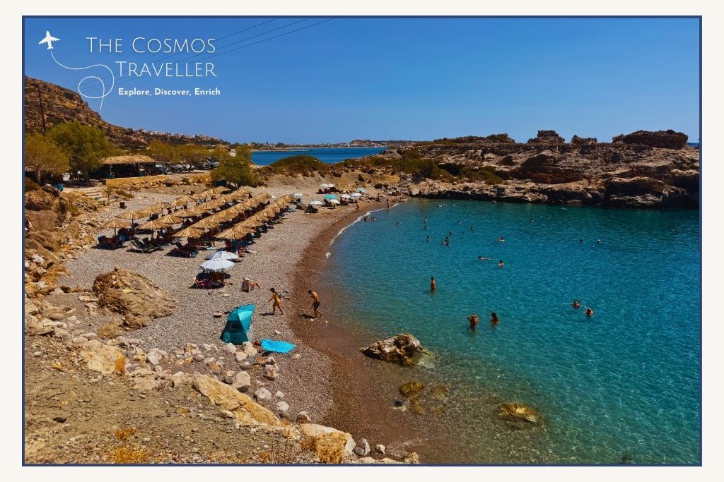 Sheltered pebble cove at Psilos Volakas Beach, Paleochora, Crete, with sunbeds and a family-friendly vibe.