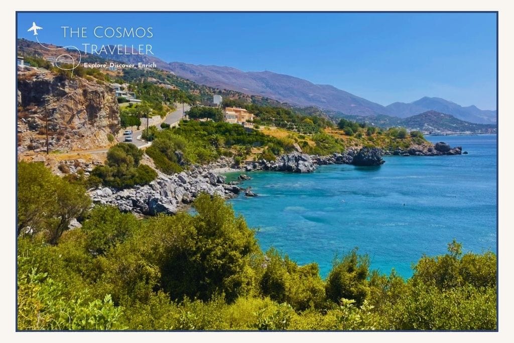 Photo of Fotinari Beach taken from the road above, showing twin pebble coves surrounded by greenery near Plakias.
