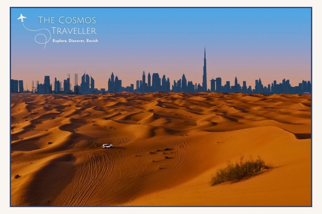 Dubai desert dunes with the skyline and Burj Khalifa in the distance.