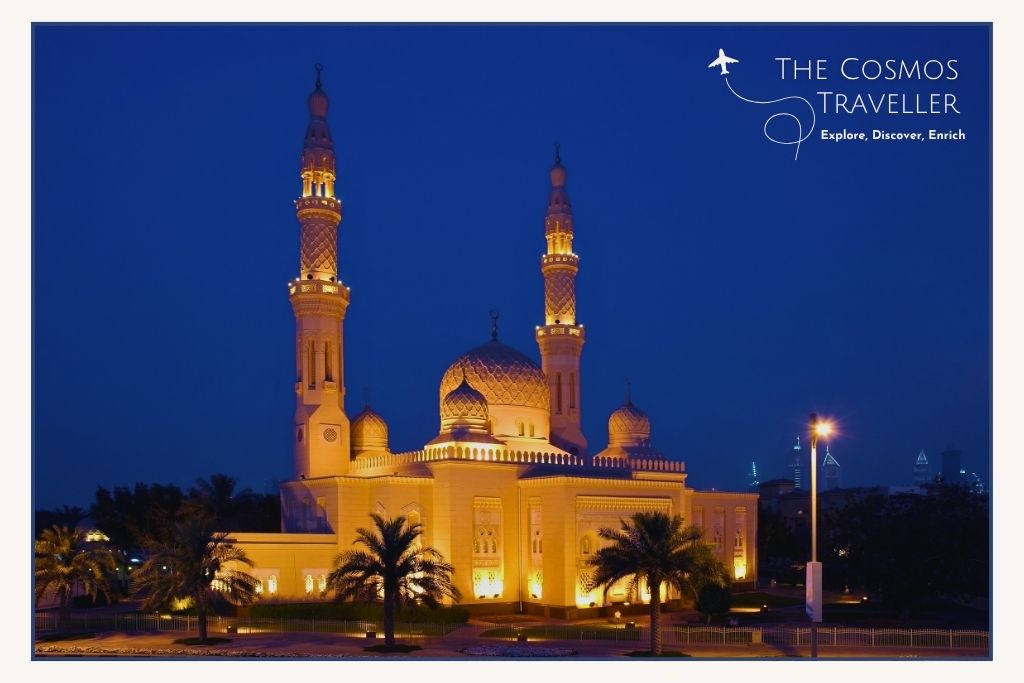 Jumeirah Mosque beautifully lit at night showcasing its minarets and Islamic architecture.