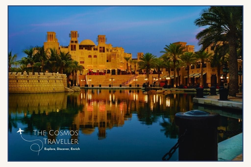 Madinat Jumeirah’s waterways at dusk with the souq visible in the distance under soft evening light.