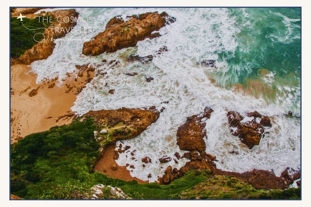 Coney Glen Beach below the Knysna Heads with rugged rocks and ocean swell.
