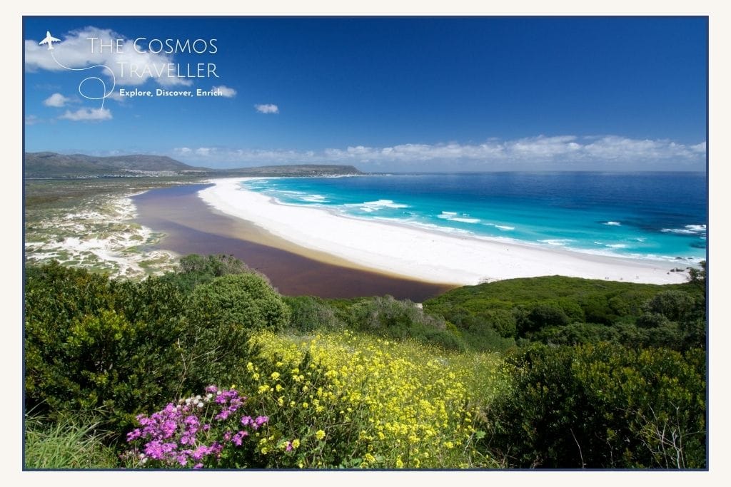 Wide sandy shoreline at Noordhoek Beach beneath Chapman’s Peak Drive.