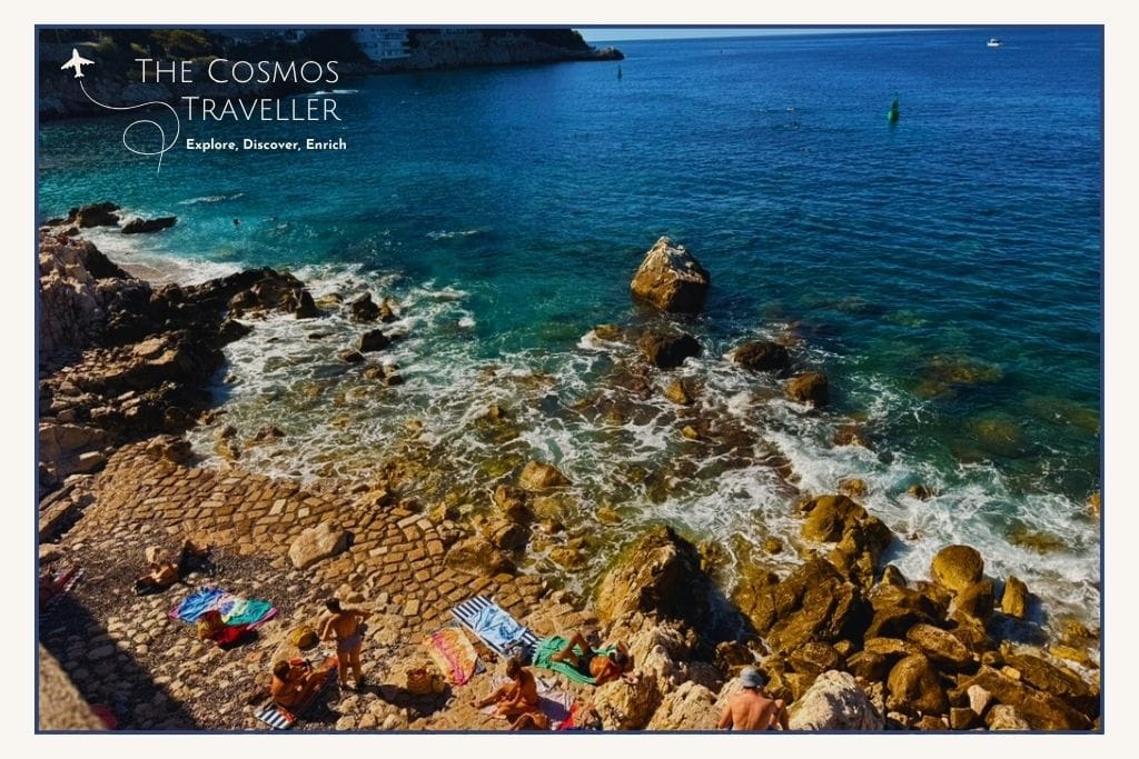 Rocky swimming platforms and clear water at Coco Beach in Nice, France