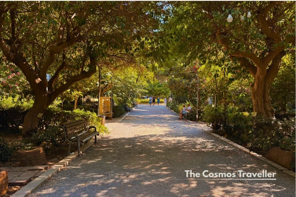 Shaded, tree-lined path through Rethymno's Municipal Garden, Crete