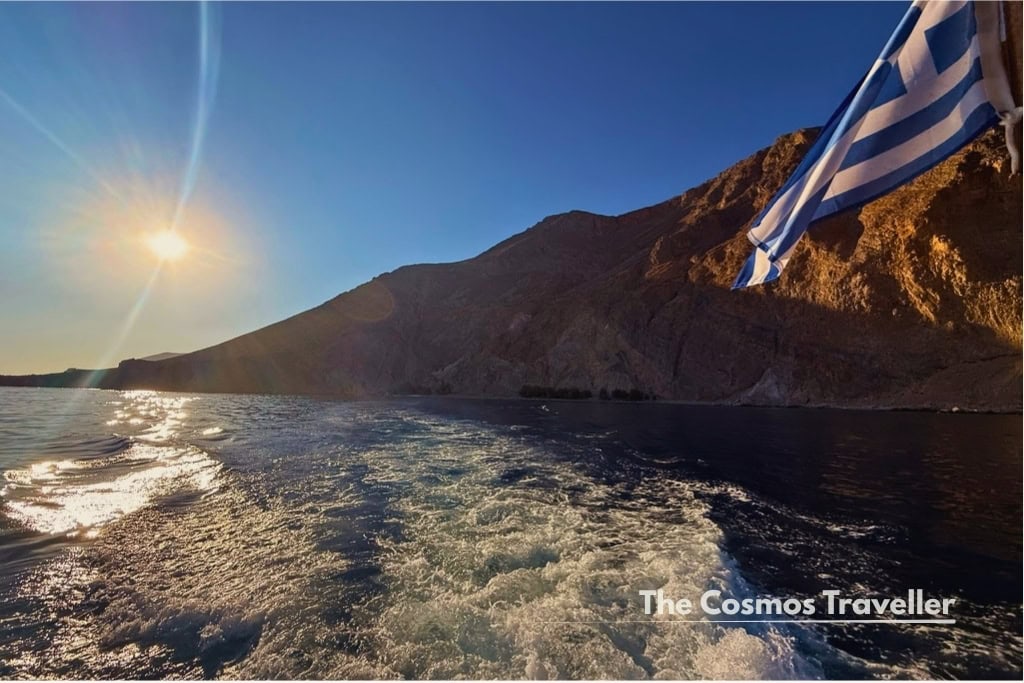Leaving Glyka Nera by Deligiannis Lines boat, with the Greek flag flying astern.