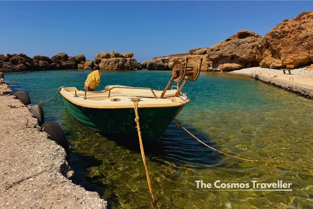 A boat moored at the harbour wall in Koutelos, Crete