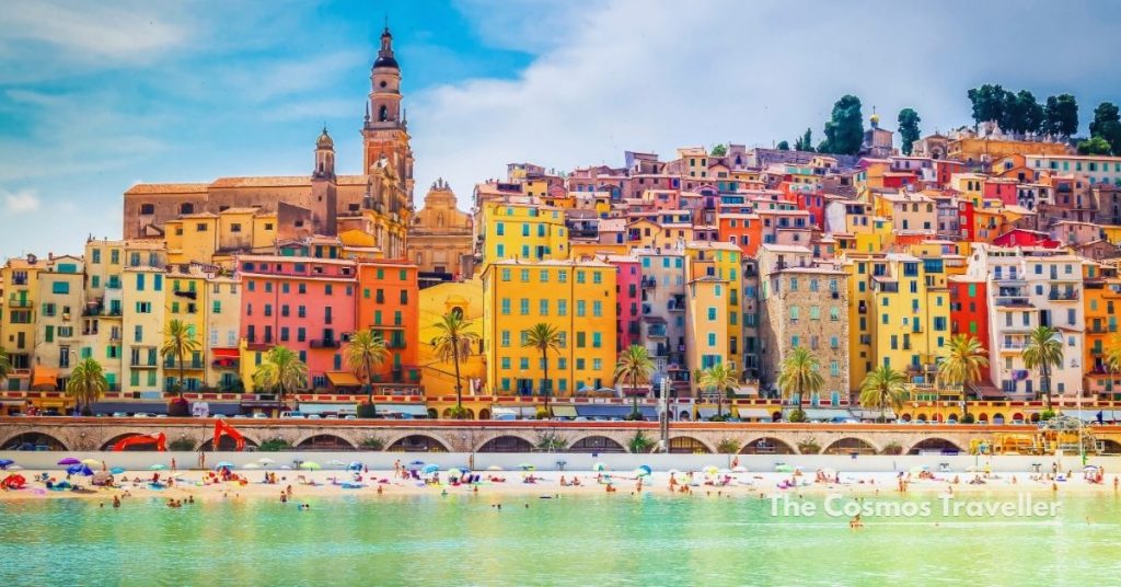 Colourful facades of Menton old town with the basilica towering above