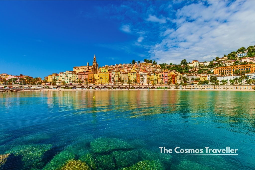 Colourful facades of Menton old town above the Plage des Sablettes